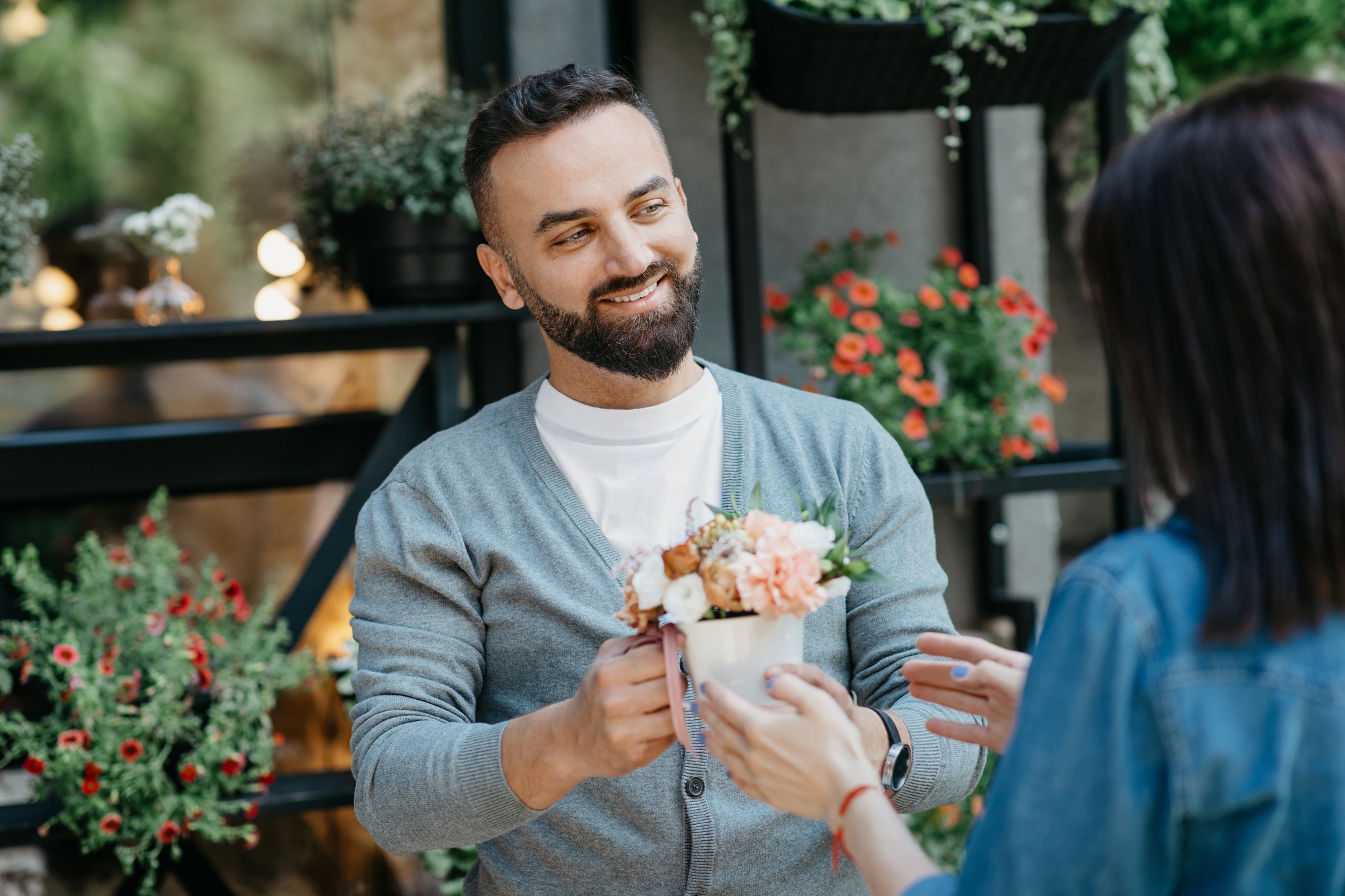 Colourful floral arrangement being handed over in a friendly outdoor setting at Brighter Websites for high-quality web design services.