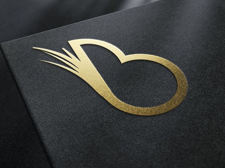 Elegant golden logo on textured black surface